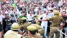 Policemen lathi-charge BJP activists in Jammu on Thursday.