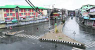A paramilitary soldier patrols the Lal Chowk area, the main business hub of Srinagar; and (right) Hari Singh High Street wears a deserted look on Thursday. 