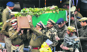 Director General of Police Ashok Prasad along with senior officers carry the body of a slain CRPF jawan at the wreath-laying ceremony in Srinagar on Thursday.