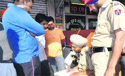 Police officials at the sweetmeat shop in Jagraon on Thursday. A tribune photograph