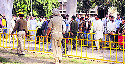 Policemen ask attendants to stay away from the entry point to the PGI in Chandigarh on Friday