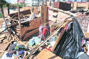 A woman goes through the rubble after an anti-enchroachment drive in Jammu on Friday.