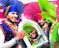 Bhangra team from a college gets dressed up ahead of a competition in folk dance at DAV College in Jalandhar on Friday. 