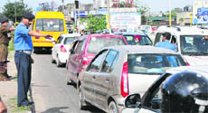 A traffic policeman directs vehicles in Jammu. 