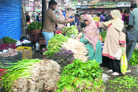 People buy vegetables after the curfew was lifted from many parts of Srinagar on Saturday.