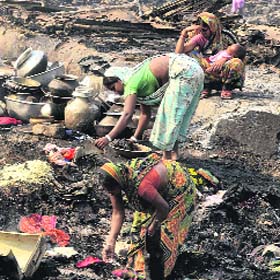 Slum dwellers search for their belongings after a major fire gutted around 700 shanties in Kolkata on Saturday