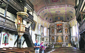 An inside view of 16th century church with tiered wooden stalls and a stunning Baroque altar Photos by the writer