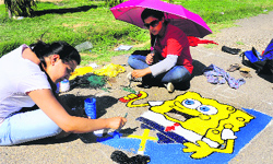 Students of the University Institute of Engineering and Technology take part in a road painting competition held on the campus on Sunday. Tribune Photo: S.Chandan 