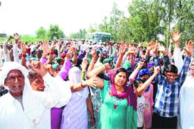 Agitators block the Hisar-Delhi National Highway near Mayyar village in Hisar on Sunday