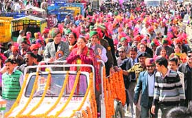 Governor Urmila Singh greets the public during the concluding procession of the week-long Mahashivratri fair in Mandi on Sunday