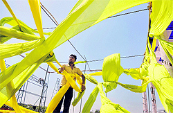 A worker removes a tent from the venue for Kisan Mela at Punjab Agricultural University in Ludhiana
