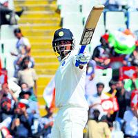 Murali Vijay acknowledges the crowd after hitting a century during the 3rd Test against Australia in Mohali on Sunday