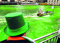 A spectator looks on as the Chicago river is dyed green ahead of the St Patricks Day parade in Chicago on Saturday