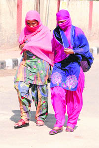 Girls wrap themselves well in a bid to escape hot weather in Bathinda. 