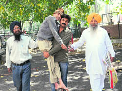 Desraj, a physically challenged retired government employee, being brought out from the UT Secretariat, Sector 9, Chandigarh, by his relatives.