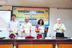 Dr Santosh Dhillon and Vice-Chancellor HS Chahal release a compilation of research papers while inaugurating a two-day national symposium at Murthal University recently. 