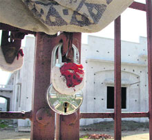 The Municipal Corporation seals an illegal building owned by an Akali leader at Shiv Nagar in Jalandhar on Monday. 