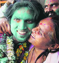 Indian sailor Saurabh Kumar, who was held captive by Somali pirates for a year, is greeted with Holi colours on his arrival at his home in Meerut on Monday. 