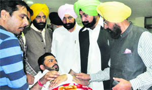 PPCC chief Partap Singh Bajwa (right) enquires about the health of party leader Rajwant Singh Shergill at PGI in Chandigarh on Monday. 