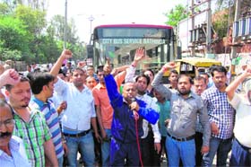 Shopkeepers of Street number 6 of Nai Basti blocking traffic on the Mall Road in Bathinda on Tuesday