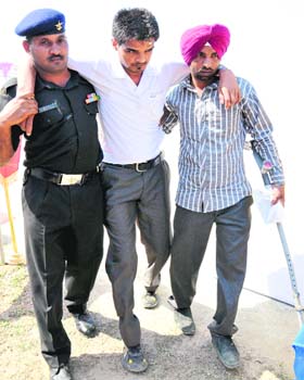 Hardeep Singh being assisted to his seat at the ex-servicemen rally held in Bathinda on Tuesday
