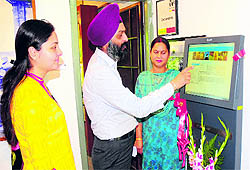 Visitors use the tourist information kiosk at the Le Corbusier Centre in Chandigarh on Tuesday