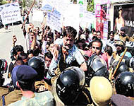 Members of the Unemployed BPEd Association clash with policemen during their protest near the state Assembly; and (right) members of the Uttarakhand Gram Pradhan Sangathan jostle with the police in Dehradun on Tuesday