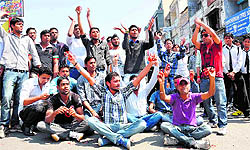 Students of Gurukul Kangri University and SMJN stage a protest on the Ranipur road in Haridwar on Tuesday