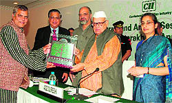Governor Aziz Qureshi presents Green Award to Sampoornanand Bharti in Dehradun on Tuesday