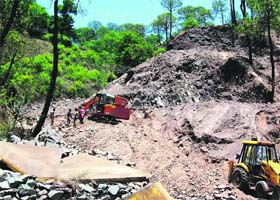 Construction work under way on the Dharampura-Kasauli road