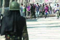 In this file photo, a security personnel stands guard to stop protesters.