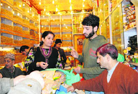 Tourists purchase dry fruits in Srinagar on Tuesday.