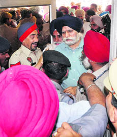 Mayor Harcharan Singh Gohalwaria (in blue shirt) struggles to gain entry into Mini-Secretariat, Ludhiana, where Deputy Chief Minister Sukhbir Singh Badal was to address a press conference on Tuesday.