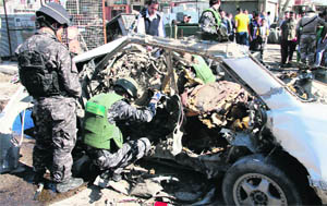 Policemen at the site of a blast in Baghdad's Sadr City on Tuesday. 