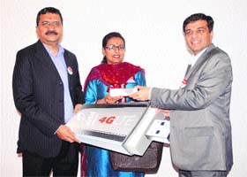 Sarang Kanade (right), COO, Upper North, Bharti Airtel, along with Jagbir Singh, CTO and Director, Network Services Group, Bharti Airtel, hand over the first 4G dongle to a woman in Chandigarh on Wednesday