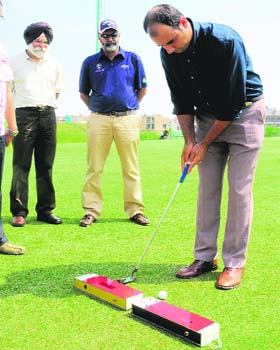 Golfer Gurbaaz Mann gives a demonstration of his new machine in Chandigarh on Wednesday