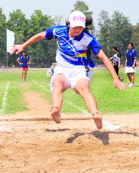 An athlete takes part in the long jump event during the annual athletics meet at PU in Chandigarh on Wednesday