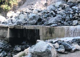 A pool still awaits repairs after it was damaged in a natural disaster last year