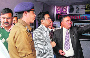 Director of State Forensic Science Laboratory attends to visitors at the exhibition at the International Shivratri Fair in Mandi. 