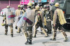 Security personnel patrol a street in Srinagar during a strike call given by separatists