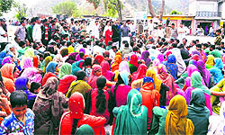 Migrants hold a protest in Talwara on Wednesday