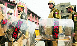 Policemen patrol a street in Srinagar on Wednesday