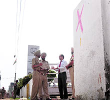 An official of a car dealer argues with police officials during the demolition drive on the main GT Road