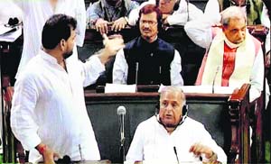 Samajwadi Party leader Mulayam Singh Yadav listens to another member in the Lok Sabha in New Delhi on Wednesday
