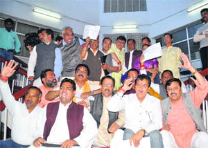 BJP legislators hold a dharna after staging a walkout from the Assembly session in Dehradun on Thursday. 