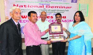 Organisers honour Dr Nivedita Hooda (right) of the CDLU during a seminar held at the National College of Education in Sirsa on Thursday. 