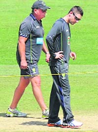 Skipper Michael Clarke along with coach Mickey Arthur inspects the pitch
