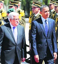 US President Barack Obama and his Palestinian counterpart Mahmoud Abbas (L) review troops in the West Bank City of Ramallah on Thursday.