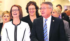 Australian PM Julia Gillard (L) with her supporters at Parliament House in Canberra on Thursday
