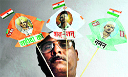 Kite maker Jagmohan Kanojia shows miniature kites with Tri-colour carrying photographs of Shaheed Bhagat Singh, Rajguru and Sukhdev on the eve of their 82nd martyrdom day in Amritsar on Friday
